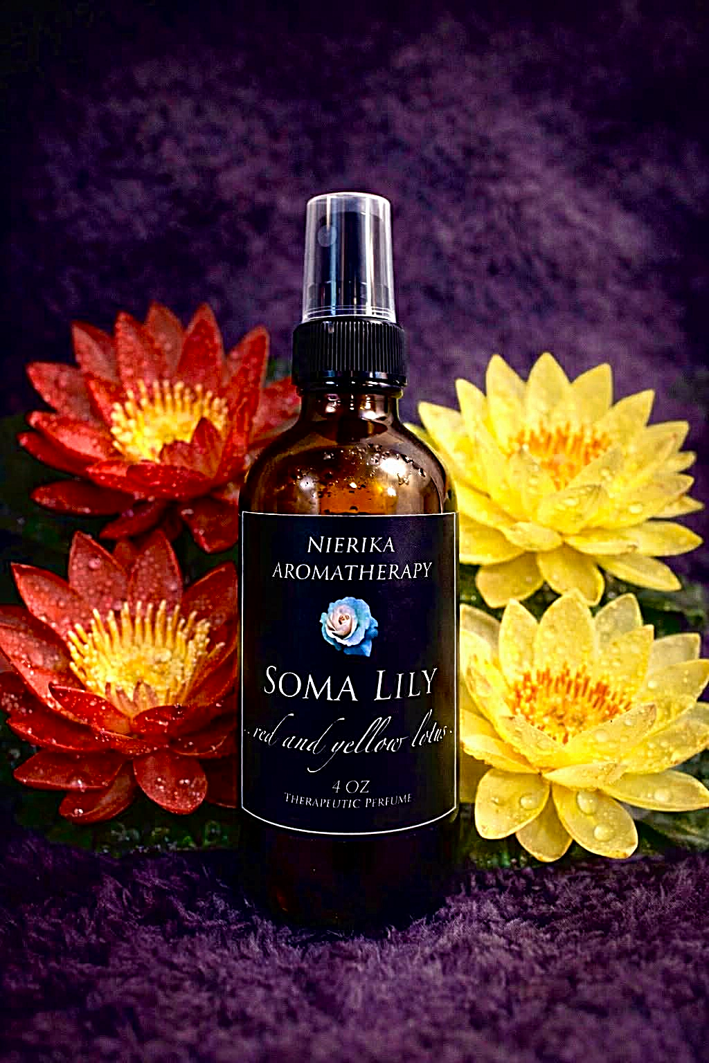 Soma Lily therapeutic perfume spray by Nierika Aromatherapy, red and yellow lotus, bottle surrounded by colorful lotus blooms – 4 oz