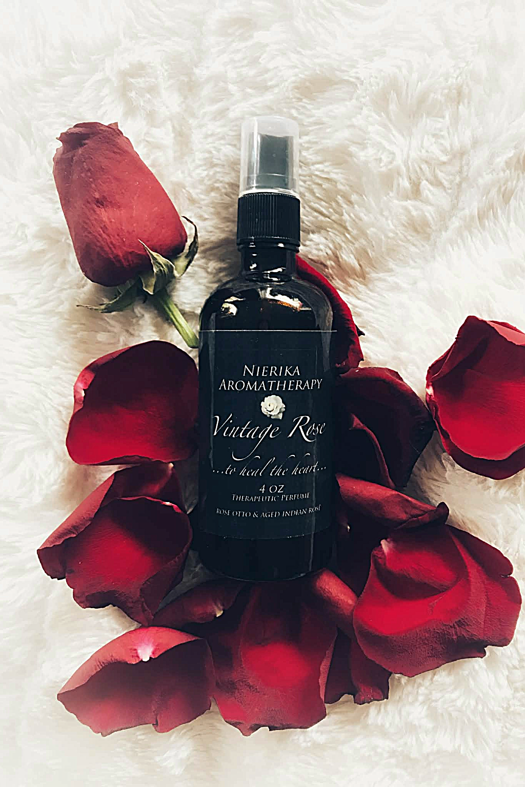 Vintage Rose therapeutic perfume spray by Nierika Aromatherapy, rose otto and aged Indian rose to heal the heart – 4 oz bottle surrounded by red rose petals